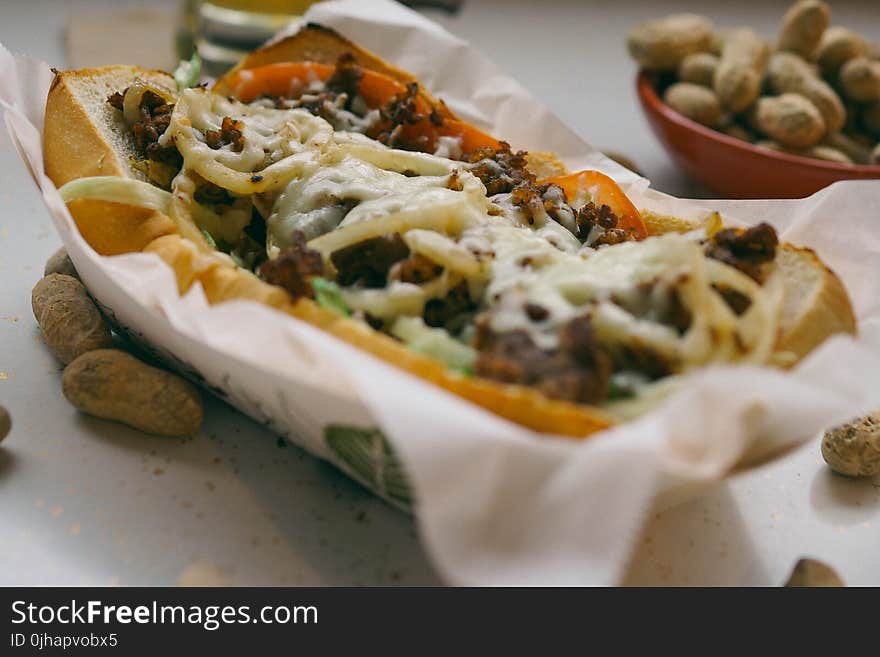 Bread With Meat and Salad Dressing on White Paper Towel on Top of Box Closeup Photography