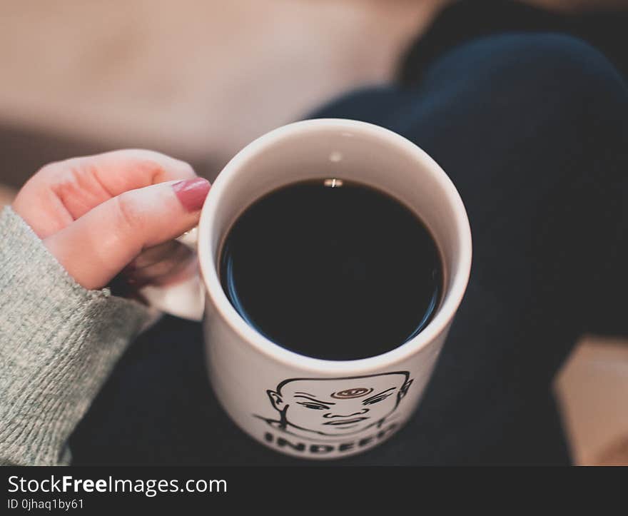 Black Beverage in White and Black Ceramic Mug