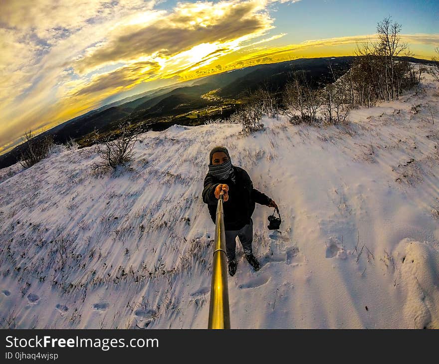 Man Standing on Snowy Terrain