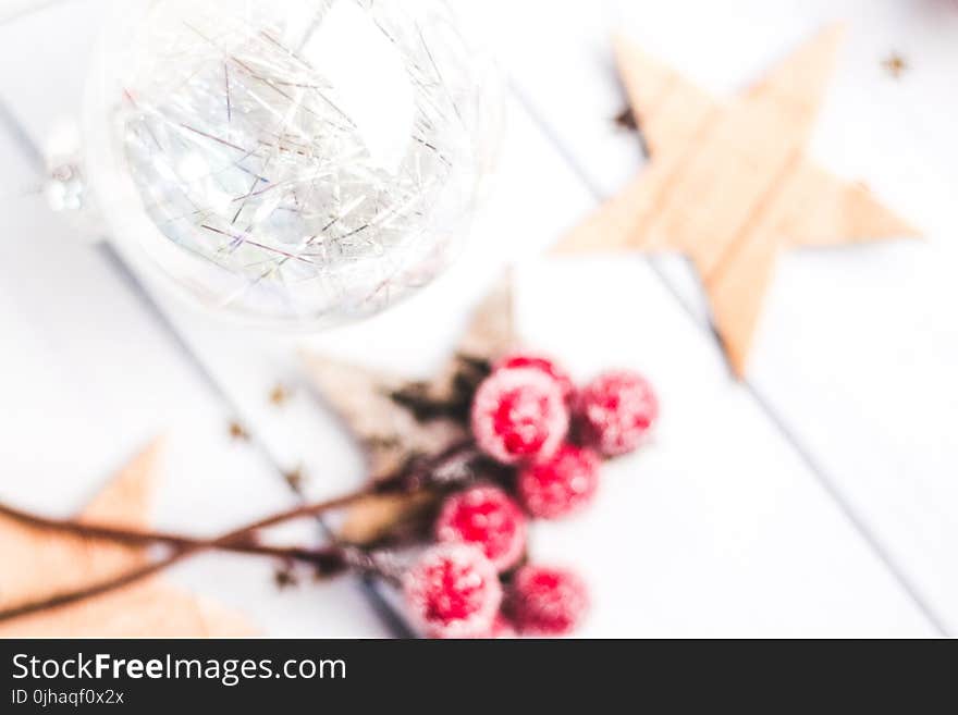 Selective Focus Photo of Clear Bauble Seeing Red Mistletoe