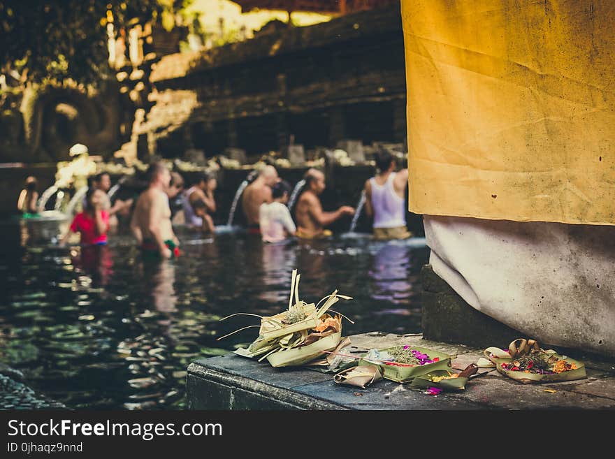 Photo of People in the Body of Water Taking a Bath