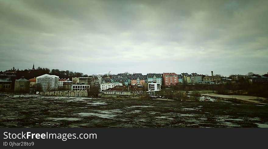 Assorted Color Concrete Building Under Cloudy Sky