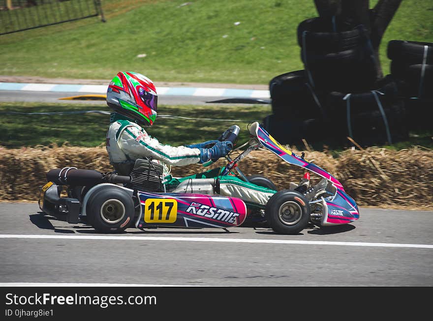 Man In Racing Suit With Helmet Riding Go Kart