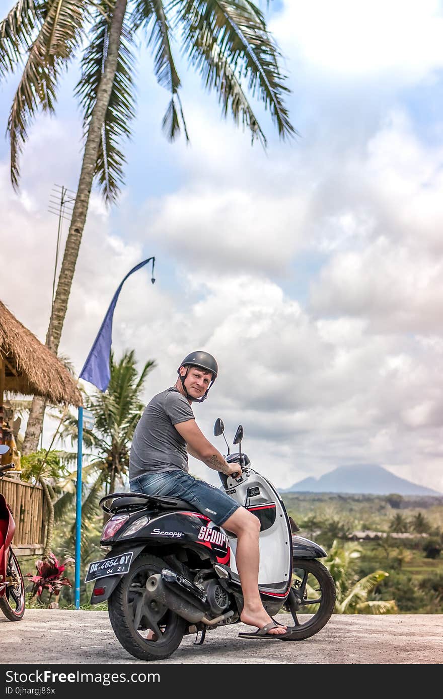 Man Riding Motor Scooter