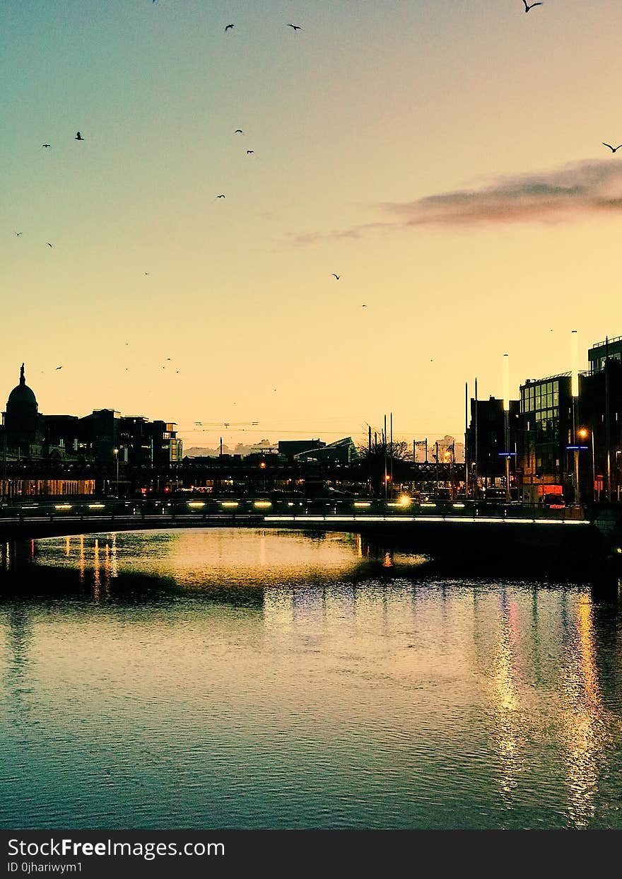 Photography of Building Beside Body of Water during Sunset