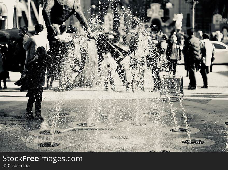 Black and White Photo of Fountain and People