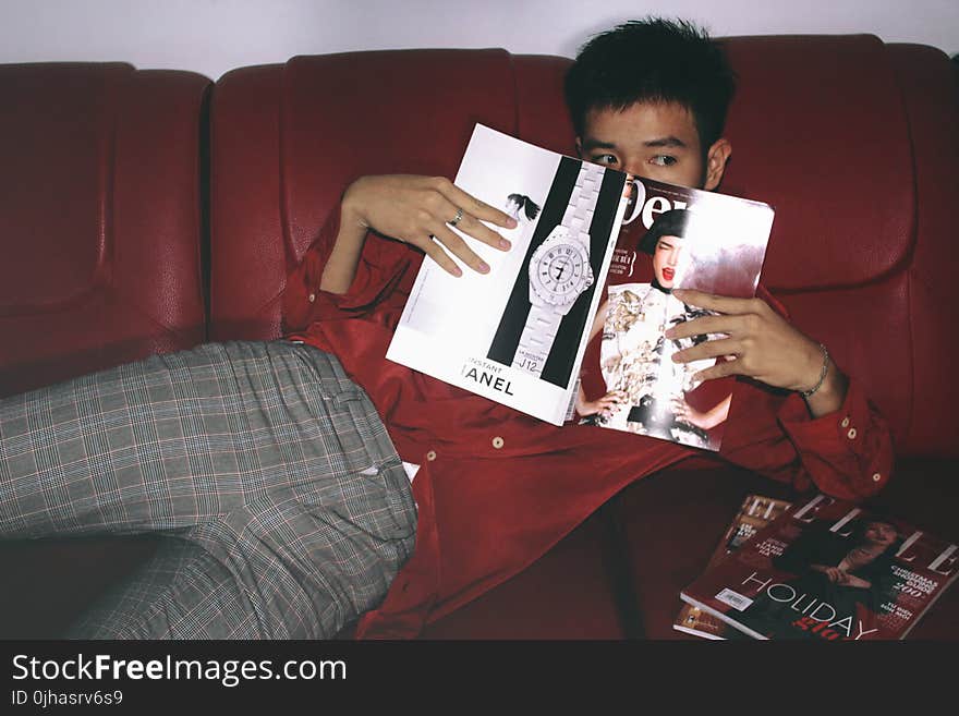 Photography of a Man Holding Magazine