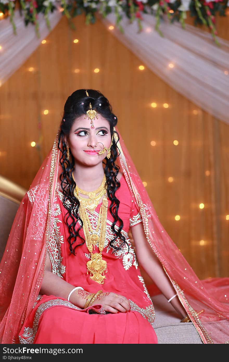 Woman in Pink and Beige Floral Traditional Dress