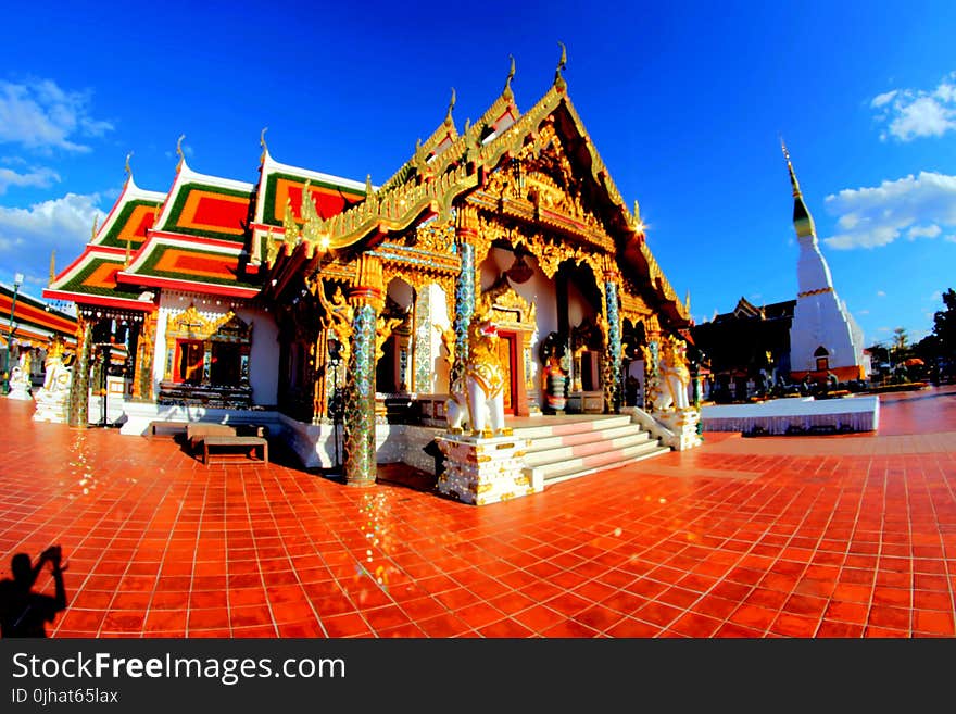 Brown and White Traditional House Under Blue Sky