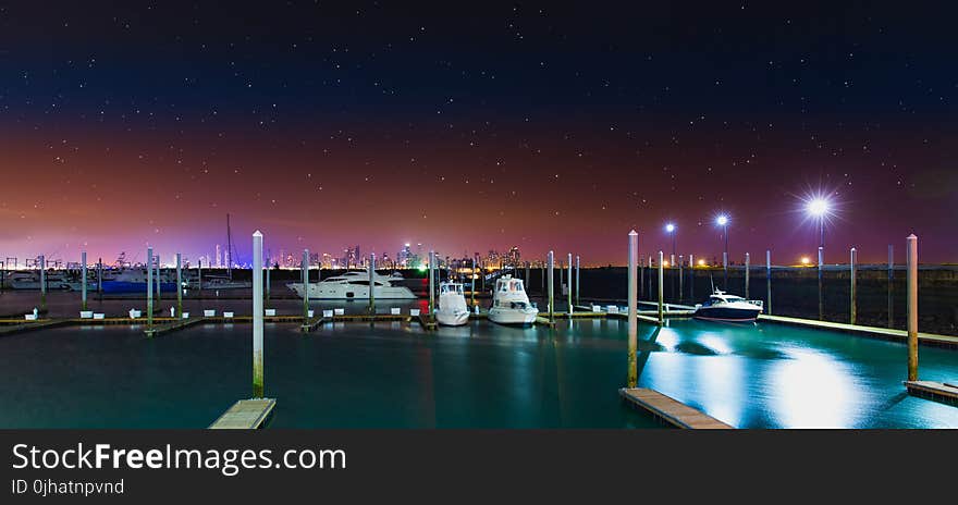 White Yacht at the Dock during Nighttime