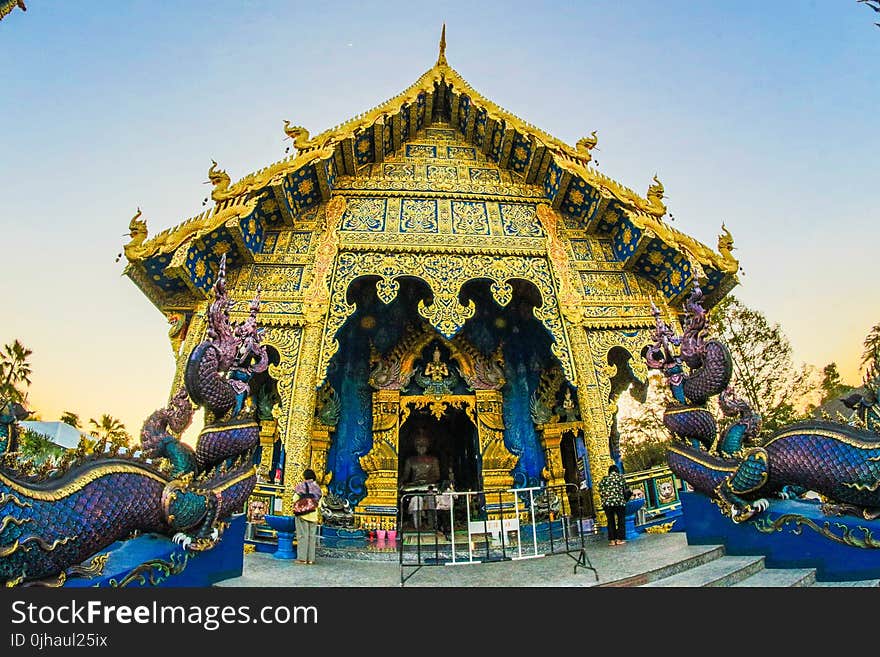 Photo of Gold-colored Altar With Dragon Figurines