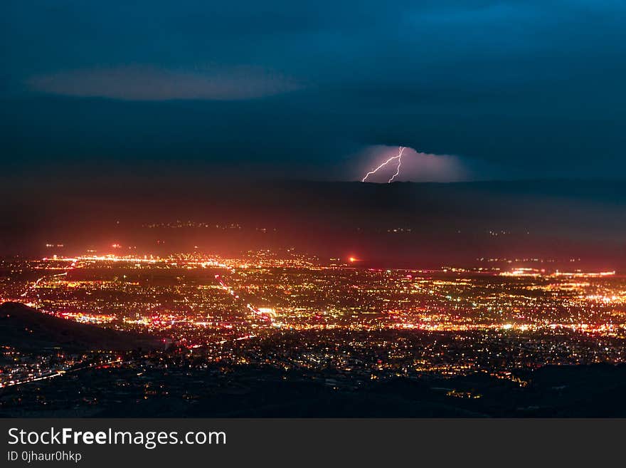 Aerial Photography of Urban City Overlooking Lightning during Nighttime