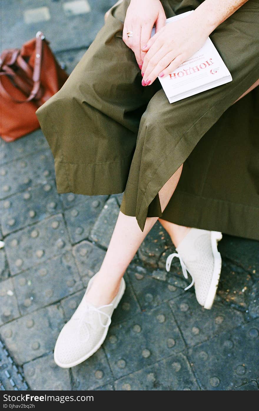 Person Wearing Green Skirt and Pair of White Low Top Sneakers