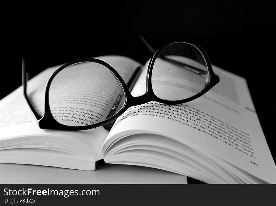 Black Framed Wayfarer Eyeglasses on Book