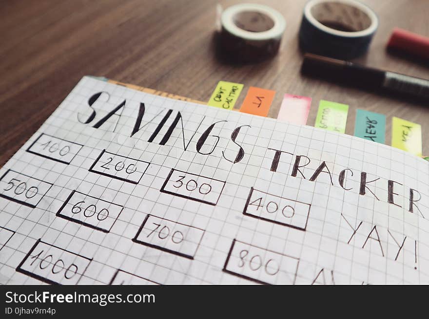 Savings Tracker on Brown Wooden Surface