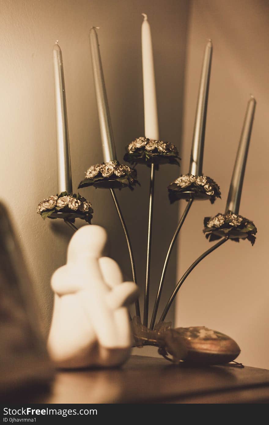 Gray Floral Candelabra on Brown Wooden Surface