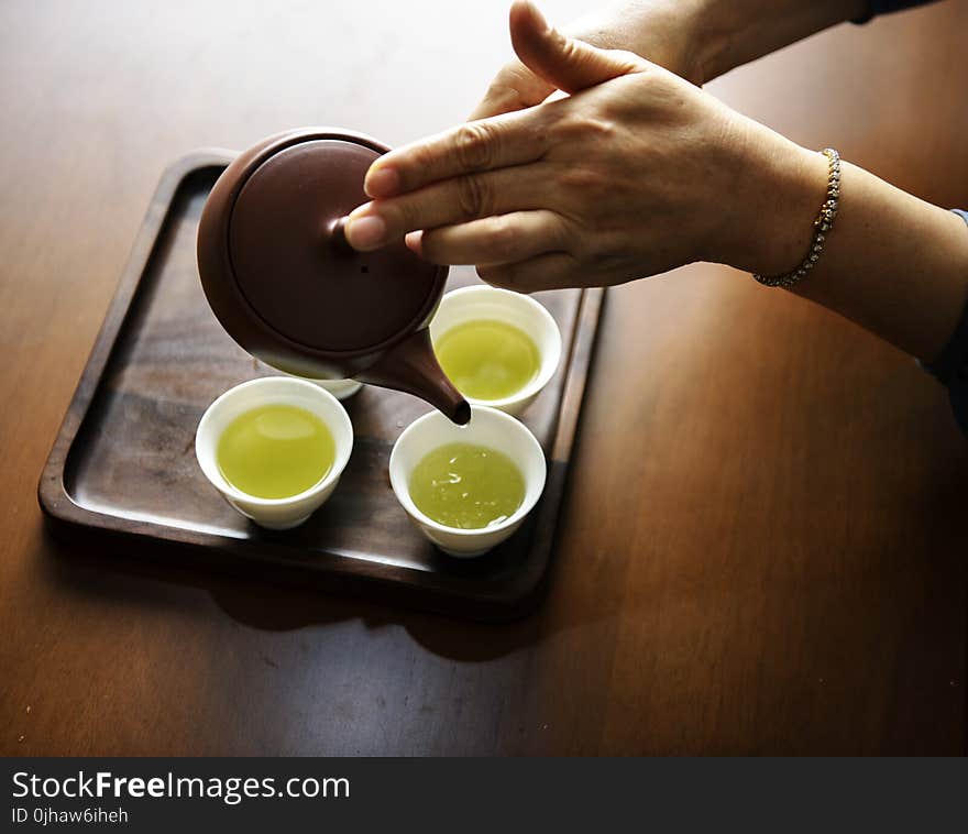 Close-up Photography of Teapot Pouring Tea