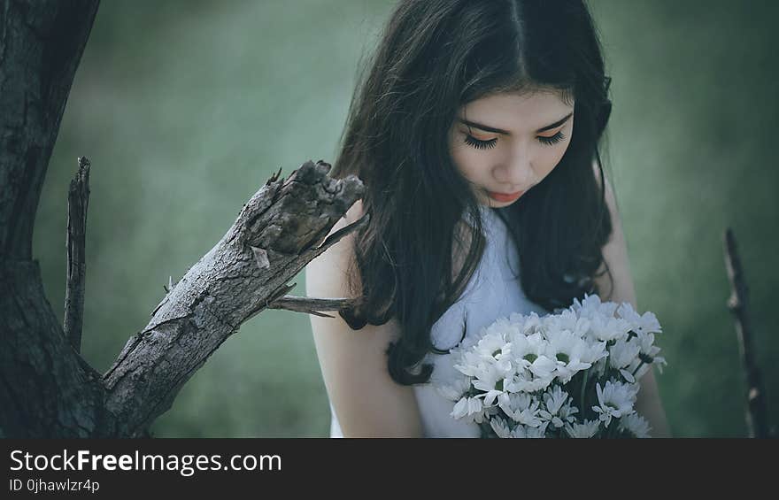 Woman Wearing White Halter Top Holding White Flower Bouquet