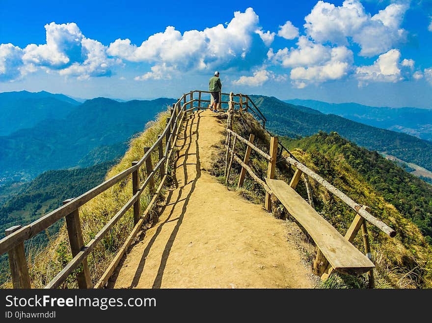 Photo of a Man Standing in the Cliff