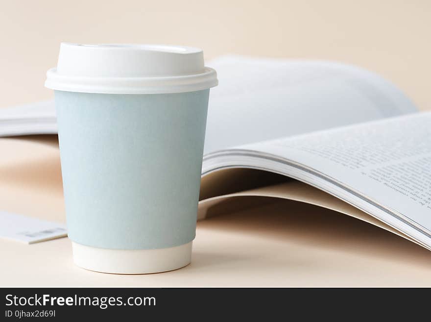 Photo of Coffee Cup Beside Book