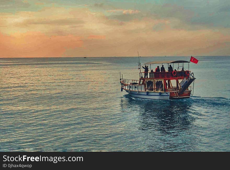 Brown and White Boat in the Middle of Ocean at Daytime