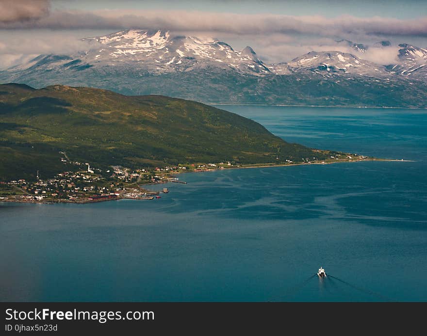 Aerial View Photography of Snow Covered Mountain Beside Ocean