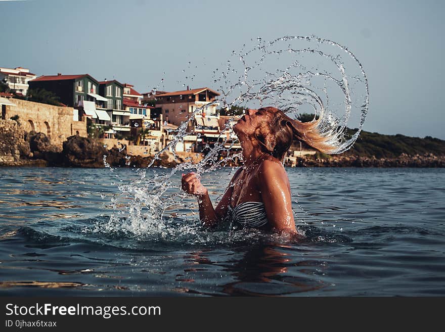 Time-lapse Photography of Woman Playing on Water With Her Hair