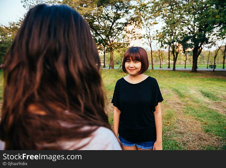 Woman Wearing Black Boat-neck Shirt on Green Grass