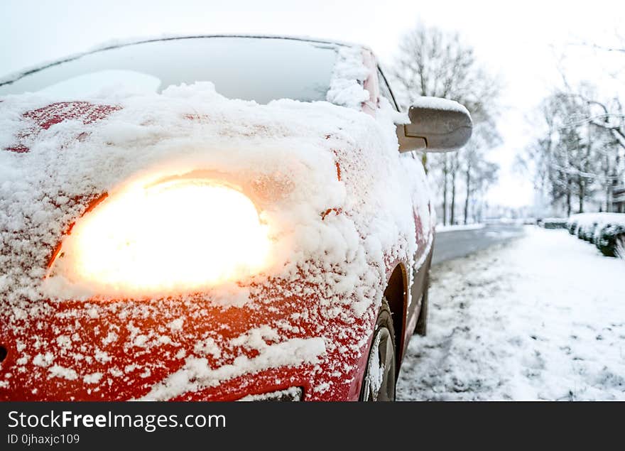 Snow Covered Red Sedan