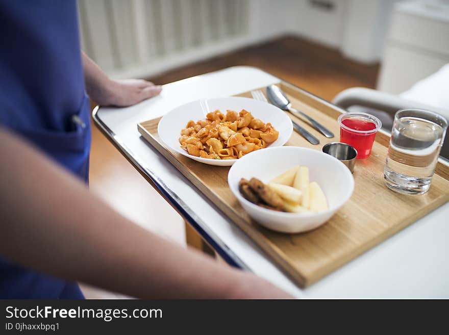 Person Standing In Front Of Food Tray