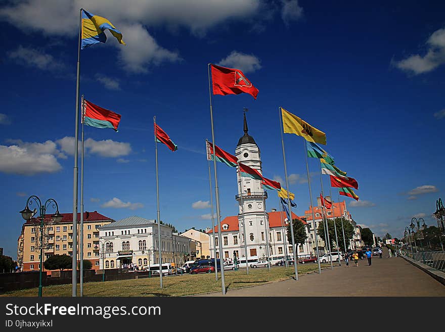 Different Flags Waving on Poles at Daytime