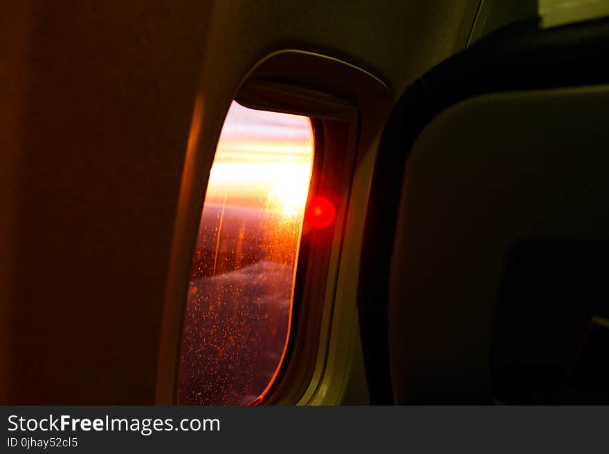 Photography of Airplane Window During Dusk