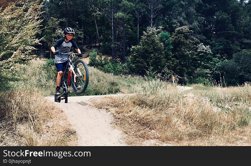 Photo of Boy Riding a Bike