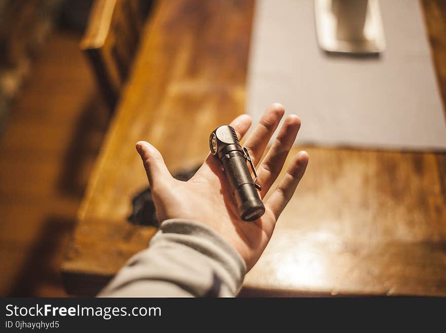 Person Left Hand Holding Stainless Steel Tool