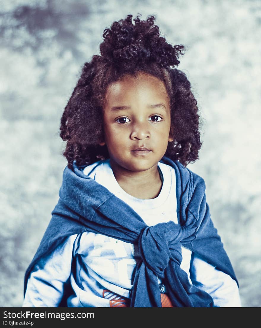 Photo of Kid With Blue Scarf and White Long-sleeve Top