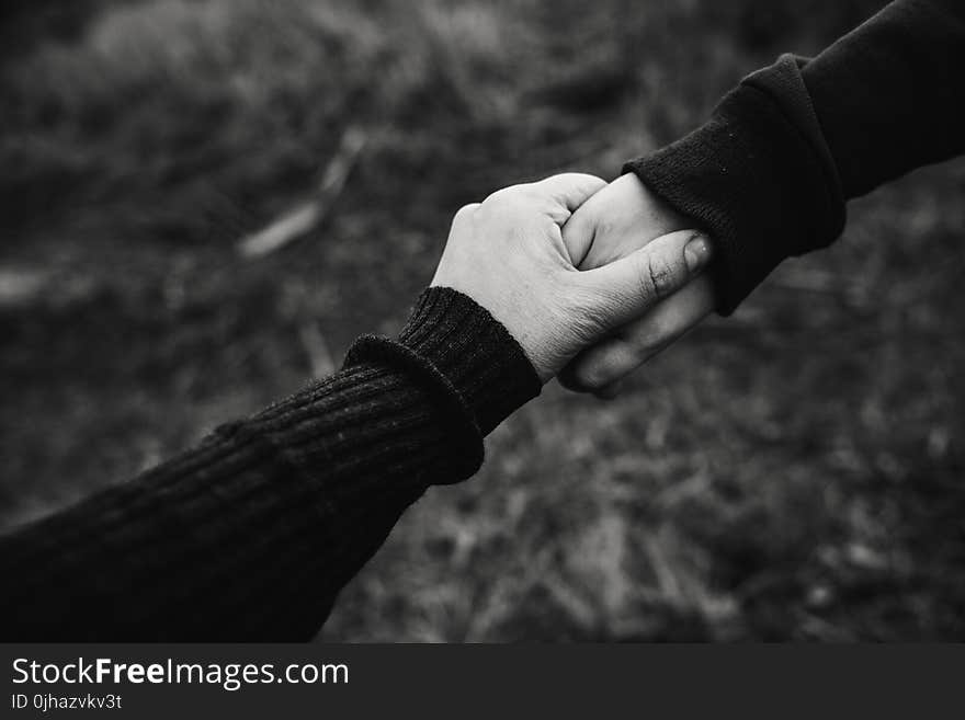 Black and White Photo of Holding Hands