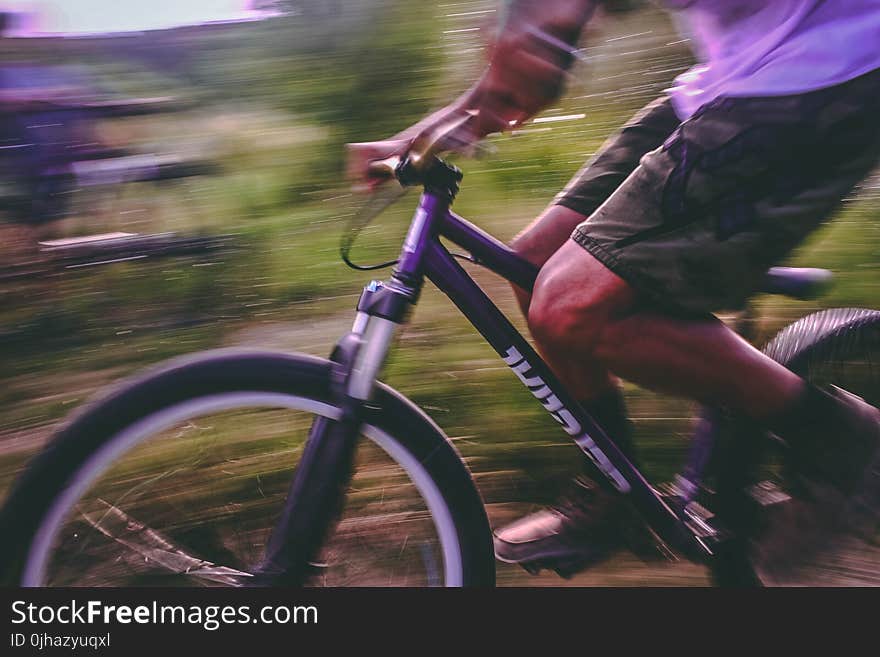 Time Lapse Photo Of Man Riding On Bicycle