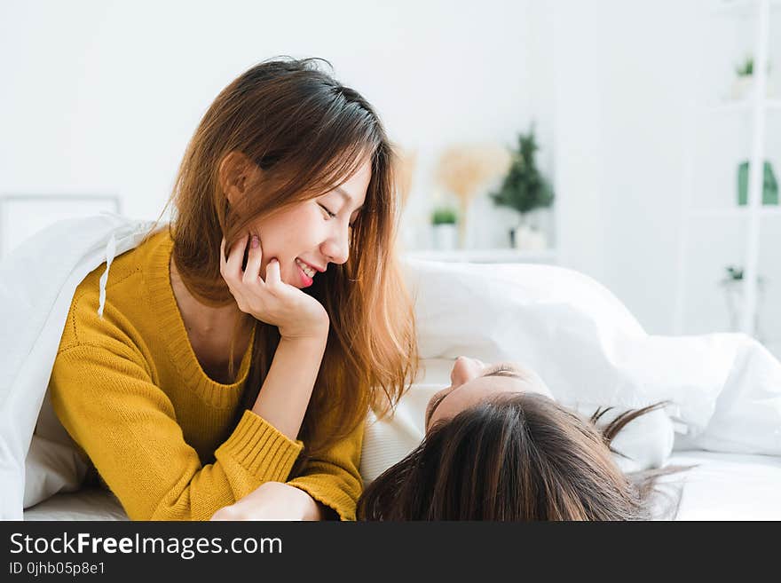 Woman Wearing Sweatshirt Lying on White Mattress