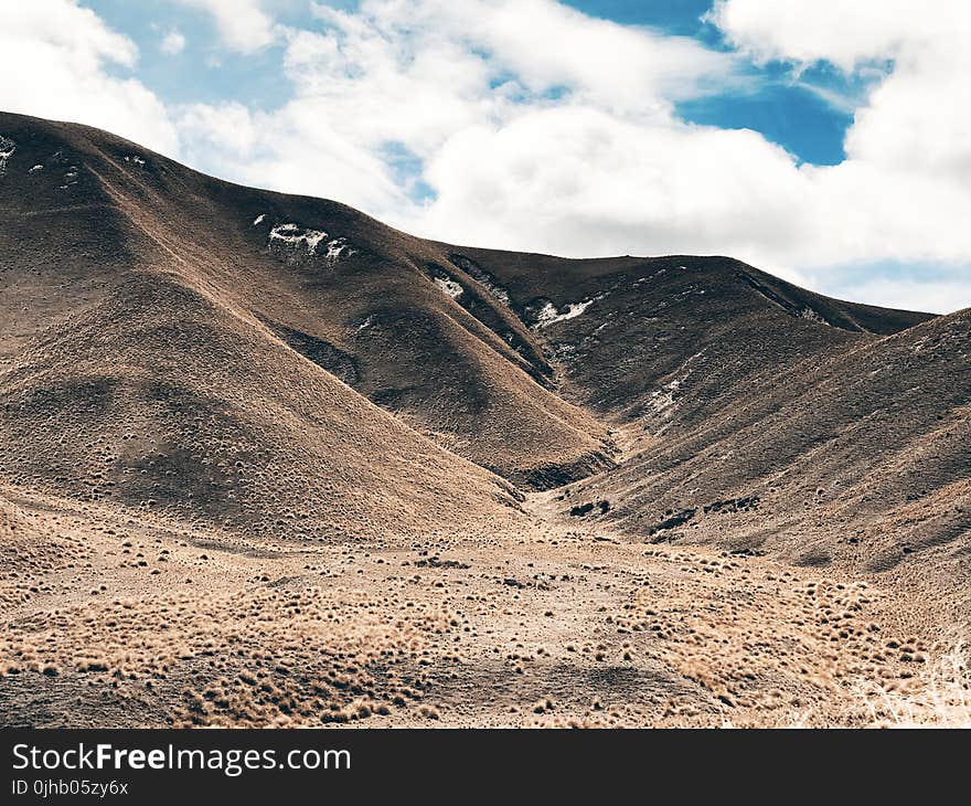 Landscape Photography Of Mountain Under White Clouds