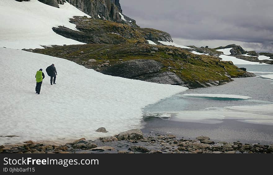 Photography of People Walking Near Body of Water