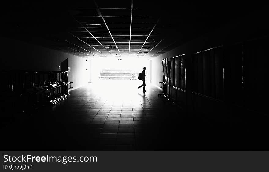 Silhouette of Man Walking on Hall