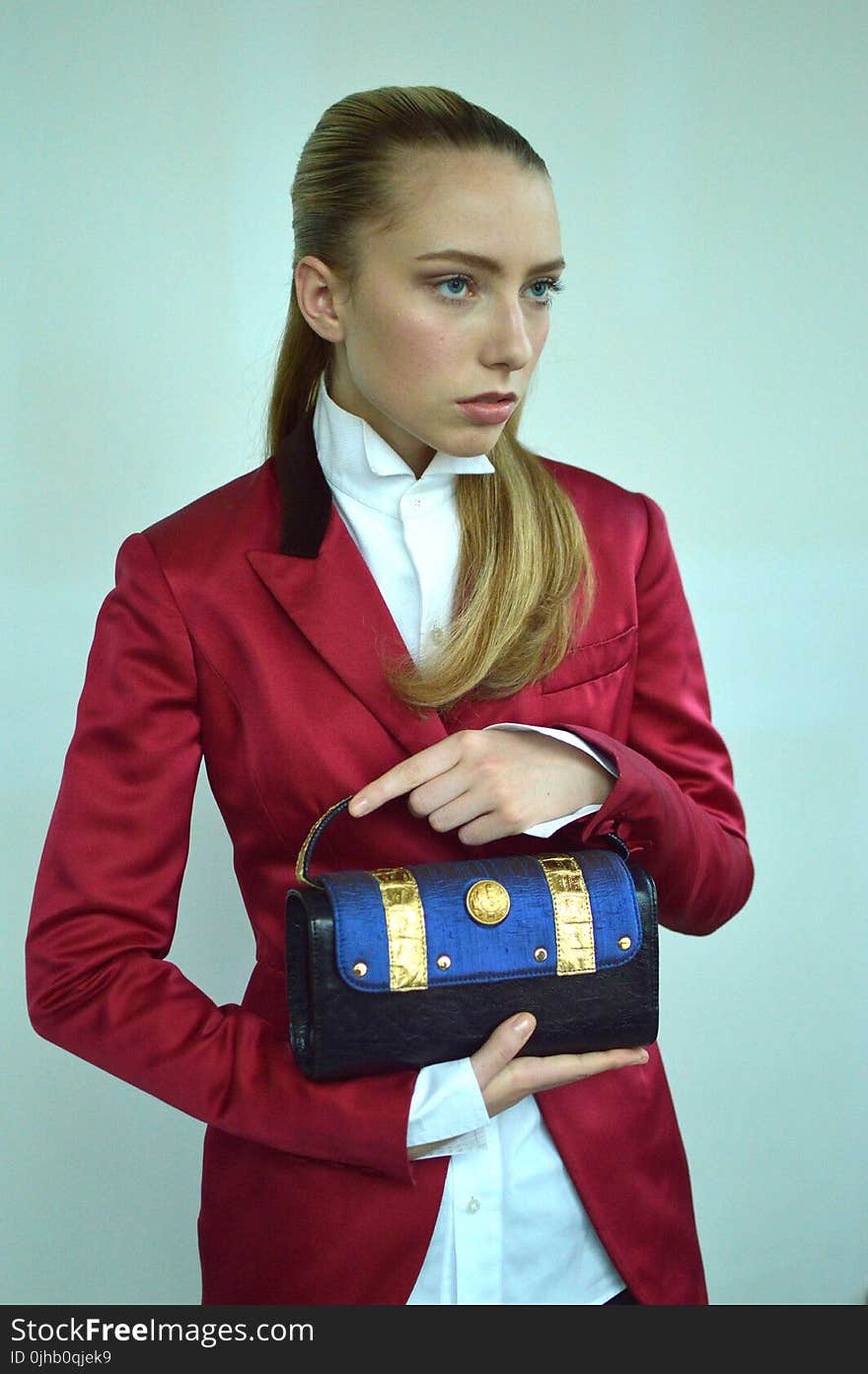 Photography of A Woman Wearing Red Formal Coat