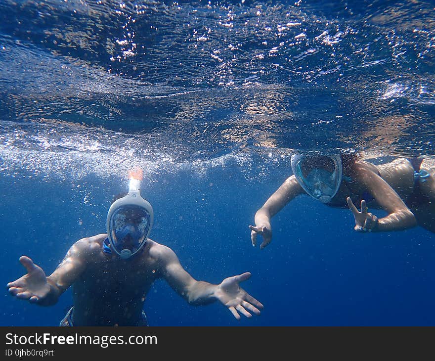 Photo of People Snorkeling Underwater