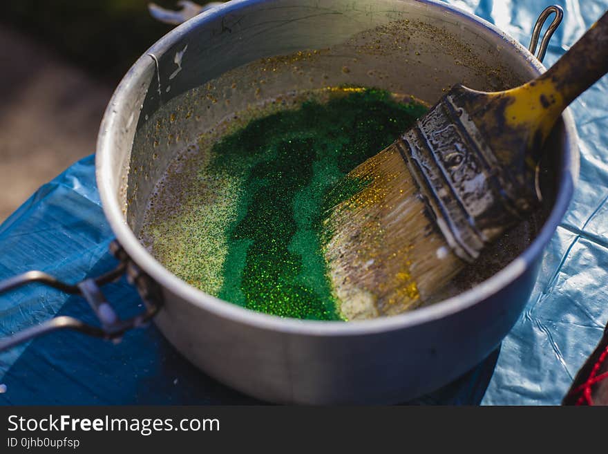 Yellow Paint Brush on Gray Steel Bucket