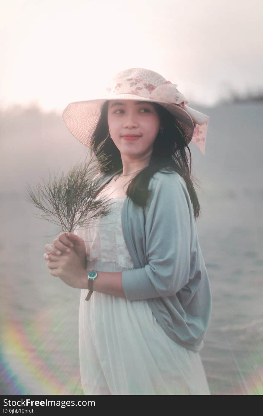 Woman Holding Brown Twig