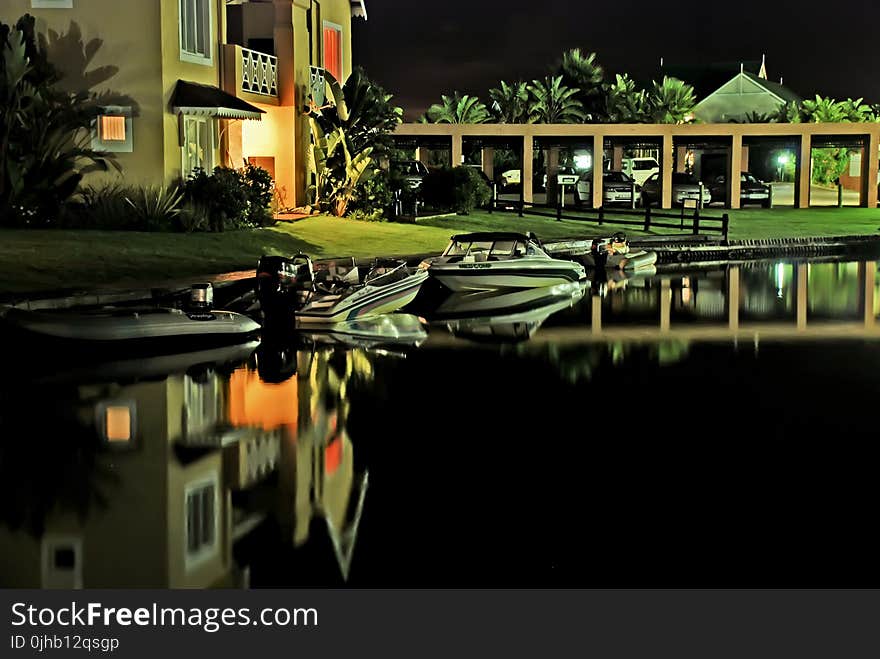 Speed Boats Docked Near House