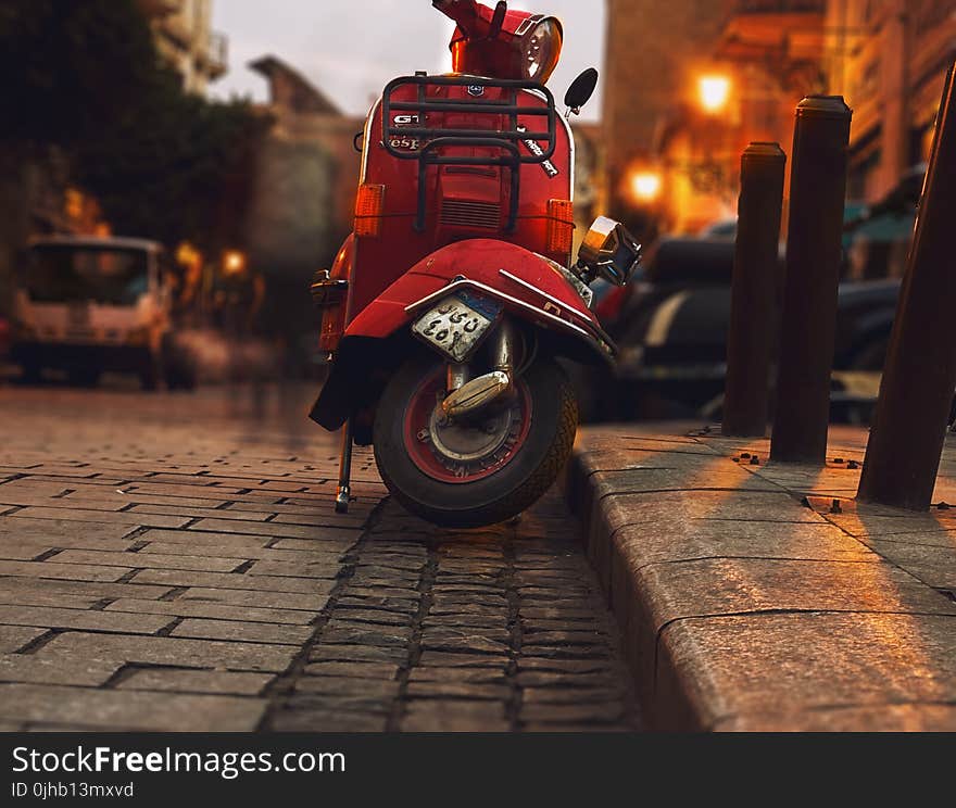 Selective Photography of Red Motor Scooter