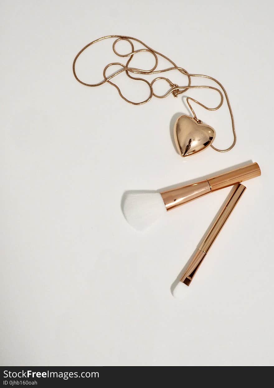 Photo of Gold Make-up Brushes and Necklace