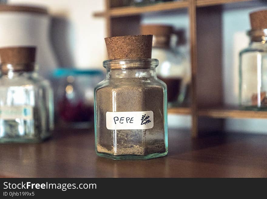 Clear Cork Bottle on Brown Wooden Table