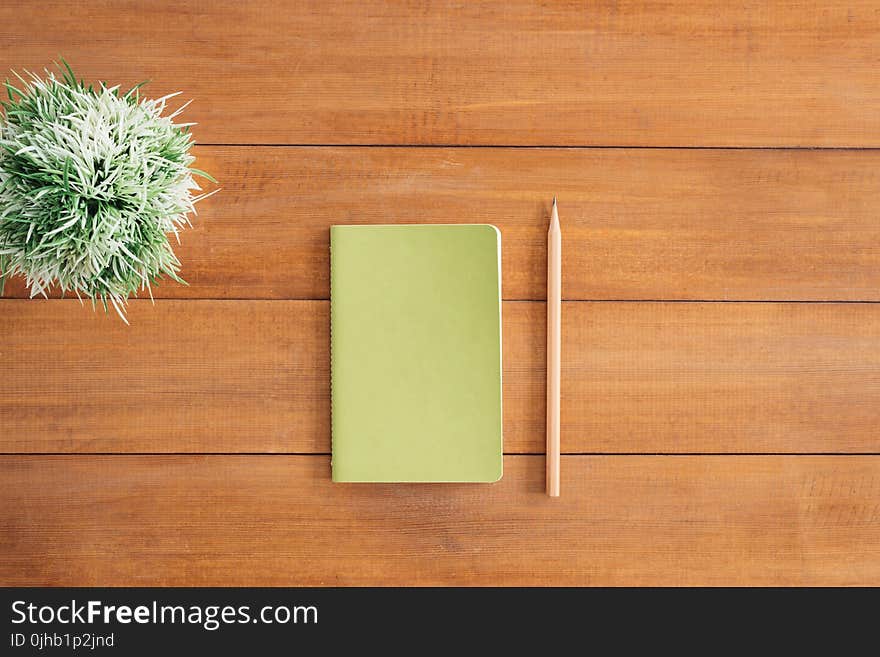 White Notes Beside a Pencil on Brown Wooden Surface